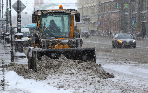 Snow removal with the help of equipment on the city street in a blizzard, Nevsky Prospekt, St. Petersburg, Russia, February 2021