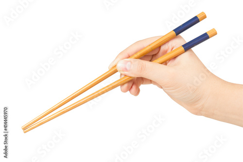 Hand holding chopstick isolated on white background.