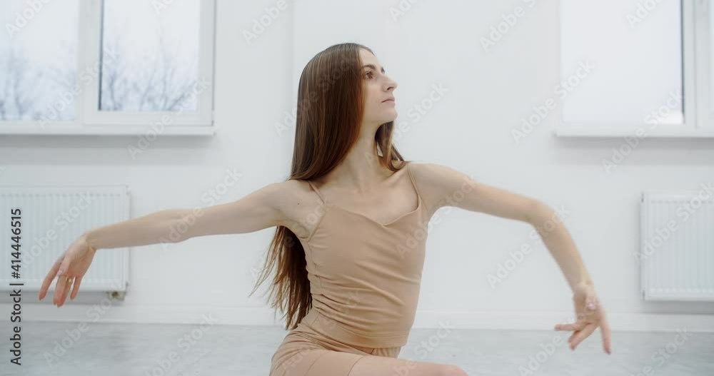 Choreographer dances on the floor of the ballet school, dancer rehearses in the white dance hall, graceful art dance in slow motion, 4k 60p Prores HQ 10 bit Choreographer dances on the floor of the ballet school, dancer rehearses in the white dance hall, graceful art dance in slow motion, 4k 60p Prores HQ 10 bit