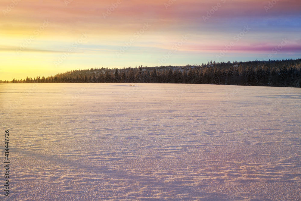 Cross country skiing. A magical start to a new day in the meadows of the Stolowe Mountains National Park in Poland. A wonderful sunrise in a wild land. Cross country skiing. A magical start to a new day in the meadows of the Stolowe Mountains National Park in Poland. A wonderful sunrise in a wild land.