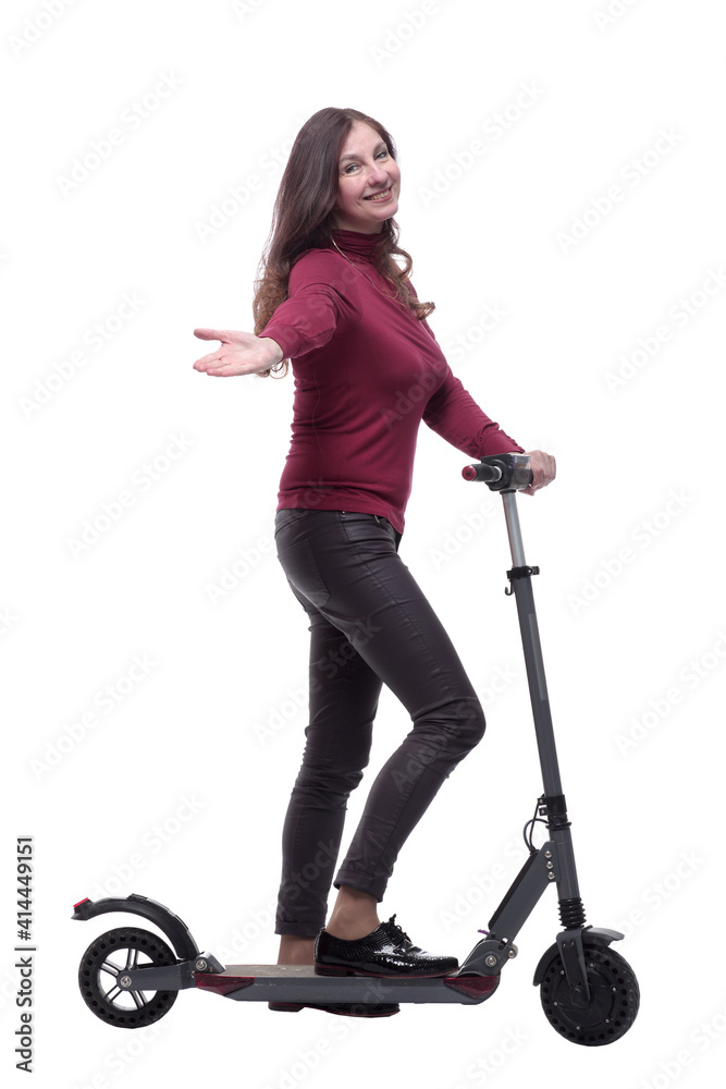in full growth. nice young woman with an electric scooter in full growth. nice young woman with an electric scooter