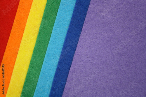 The background is made of felt of rainbow colors. Top view.