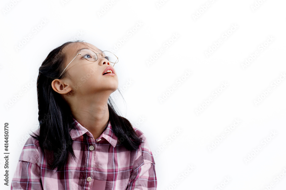 Portrait of little Asian girl wearing glasses and looking up isolated on white background. Copy Space Portrait of little Asian girl wearing glasses and looking up isolated on white background. Copy Space