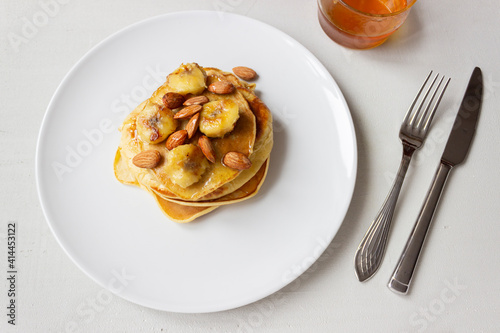 Pancakes with honey and banana on a plate. Banana pancake. Healthy food. Ketogenic diet.
