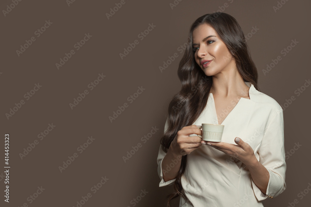 Beautiful healthy woman enjoying coffee on brown banner background Beautiful healthy woman enjoying coffee on brown banner background