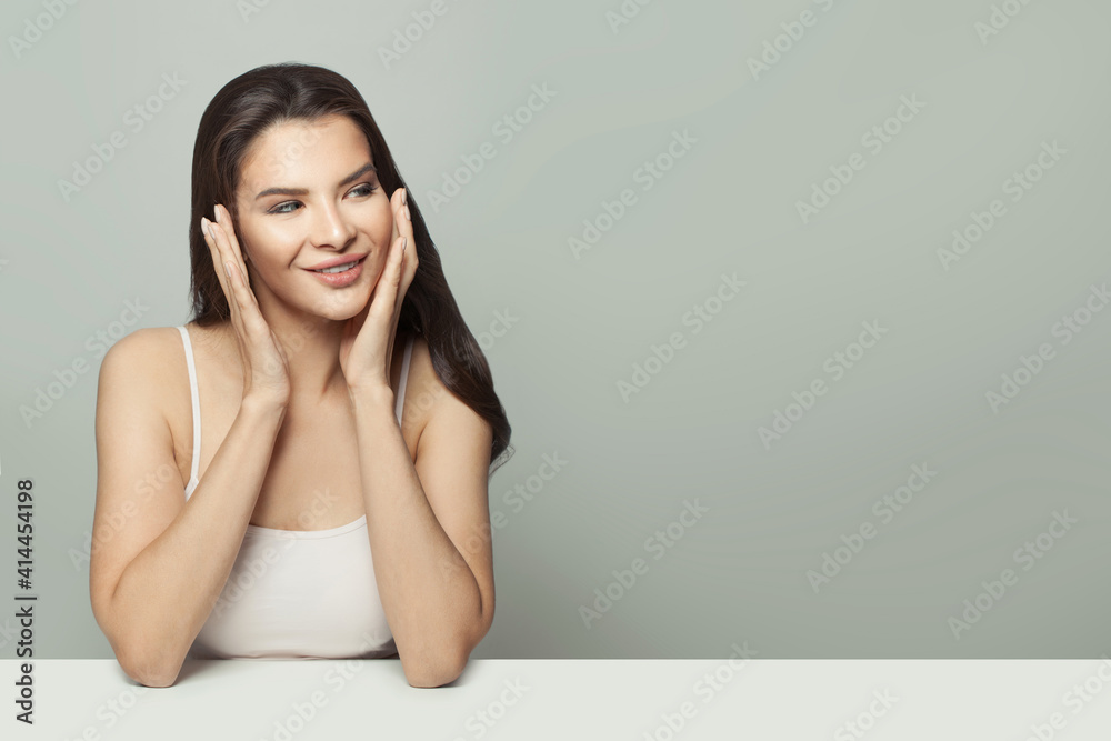 Healthy woman holding her hands near her face. Massage, face gymnastics and cosmetology concept Healthy woman holding her hands near her face. Massage, face gymnastics and cosmetology concept