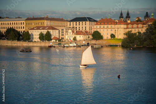 Photography Sailing on the Vltava river by Charles Bridge in Prague.