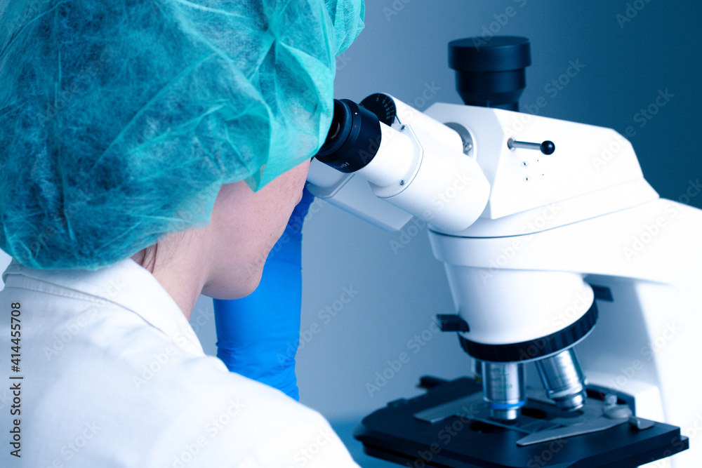Biologist watching at micrscope Biologist watching at micrscope