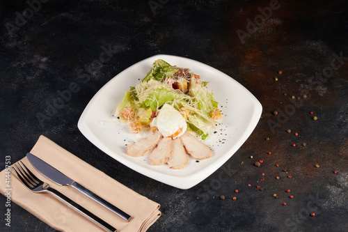 Fresh caesar salad on plate with parmesan cheese