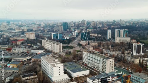 Aerial drone view of Chisinau. Panorama view of multiple buildings, roads with moving cars and bare trees. Cloudy weather. Moldova photo