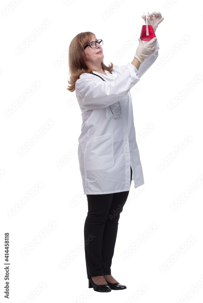 in full growth. female doctor looking at liquid in a laboratory flask in full growth. female doctor looking at liquid in a laboratory flask