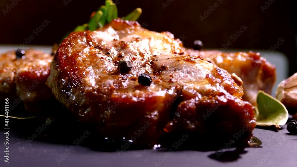 Fried pork steak on a plate. Meat dish close-up. Juicy chop.
