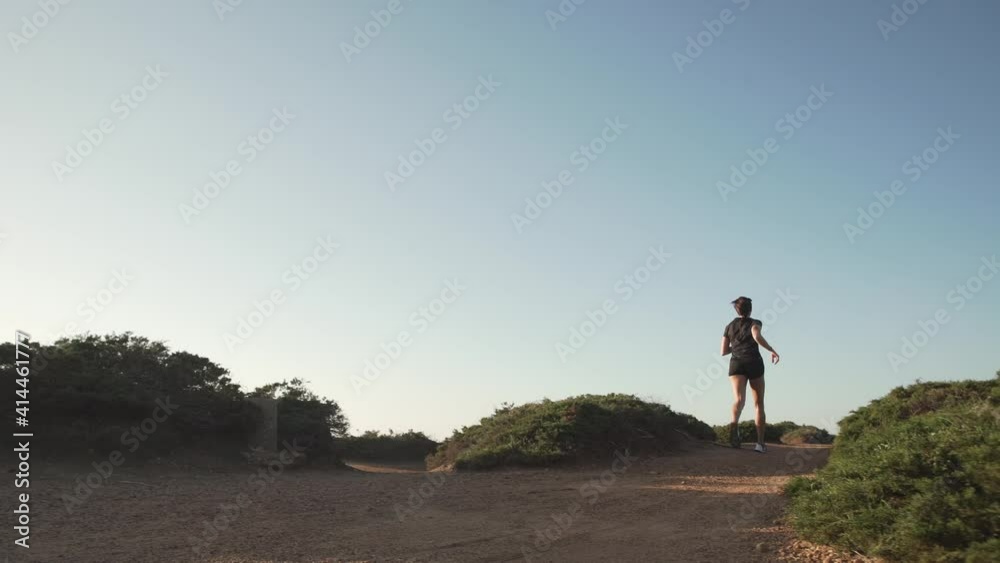 Sportswoman jogging on picturesque seashore Sportswoman jogging on picturesque seashore