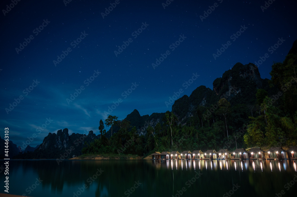 Landscape of lake with floating houses in the dark night Landscape of lake with floating houses in the dark night