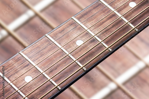 Guitar fret isolated. Music background. Wooden guitar part close up. Guitar strings background.