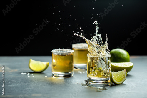 Mexican tequila with lime and salt on stone background. concept luxury drink. Alcoholic drink. Freeze motion, drops in liquid splash Mexican national drink. space for text photo
