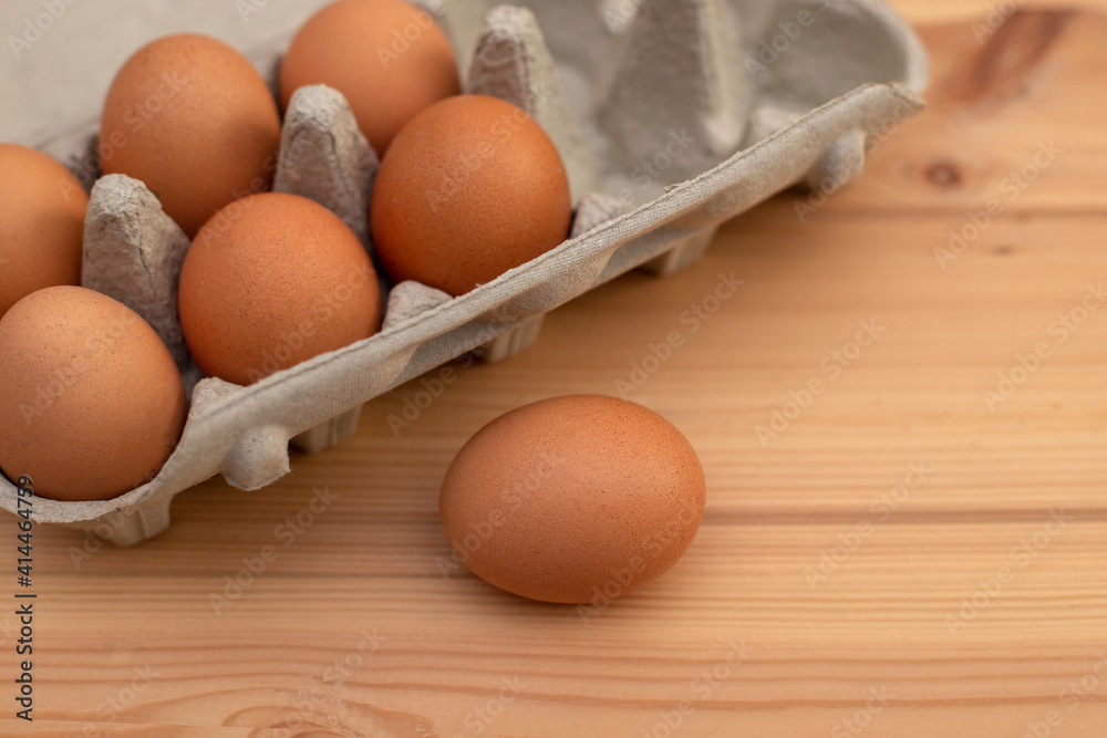 eggs in a package on a wooden table, ingredients eggs in a package on a wooden table, ingredients