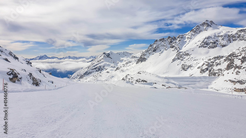 Beautiful and serene landscape of mountains covered with snow in Moelltaler Gletscher, Austria. Thick snow covers the slopes. Clear weather. Perfectly groomed slopes. Massive ski resort.