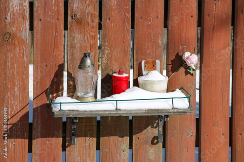 memory candles on wooden fence in winter
