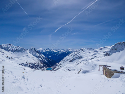 Beautiful and serene landscape of mountains covered with snow in Moelltaler Gletscher, Austria. Thick snow covers the slopes. Clear weather. Perfectly groomed slopes. Massive ski resort. photo