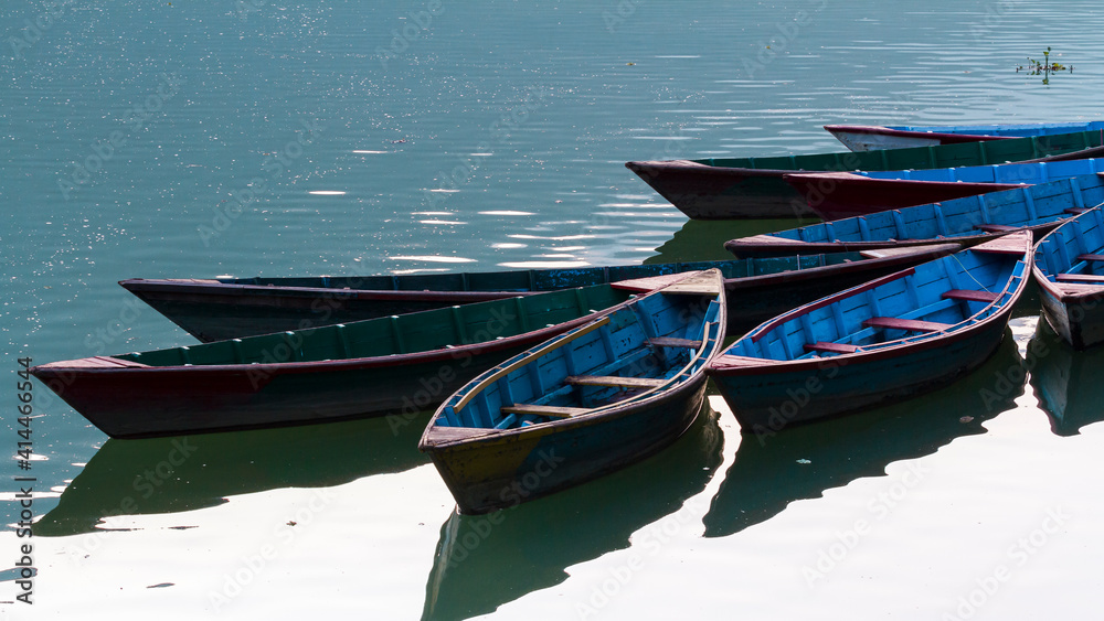 Multi-colored wooden boats on the Phewa lake, Pokhara, Nepal