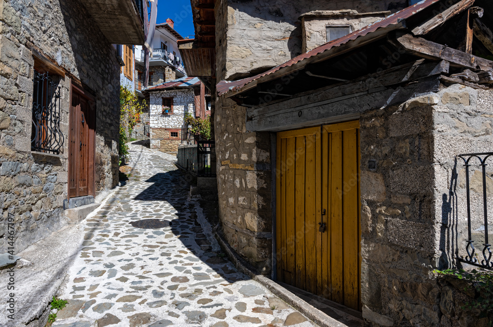 Stone houses of traditional architecture and cobble-stone narrow street in the town of Metsovo, Greece