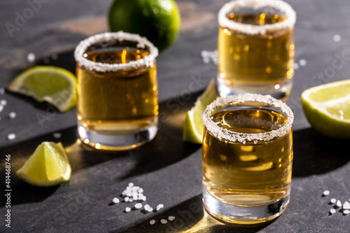 shots of gold Mexican tequila with lime and salt. Alcoholic Mexican national drink