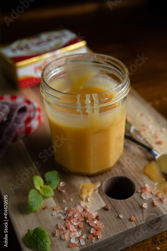 Homemade salted caramel in jam jar, butter cream sauce