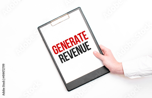 A businessman holds a folder with paper sheet with the text GENERATE REVENUE. Business concept.