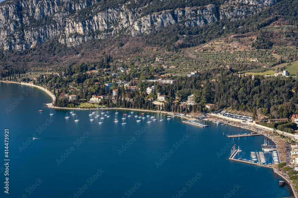 Naklejka premium Aerial View of the Small Garda Town, tourist resort on the coast of Lake Garda, view from the Rocca di Garda, small hill overlooking the lake. Verona province, Veneto, Italy, Europe.