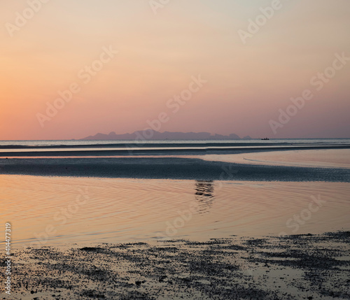 Pastel color of Sky background and Sea beach in morning time reflection of sunrise shining around