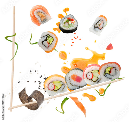 sushi rolls and ingredients with wooden chopsticks  on white background