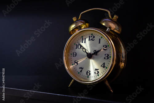 Vintage alarm clock on dark background