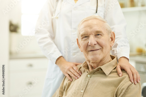 Contented elderly man posing with his medical doctor
