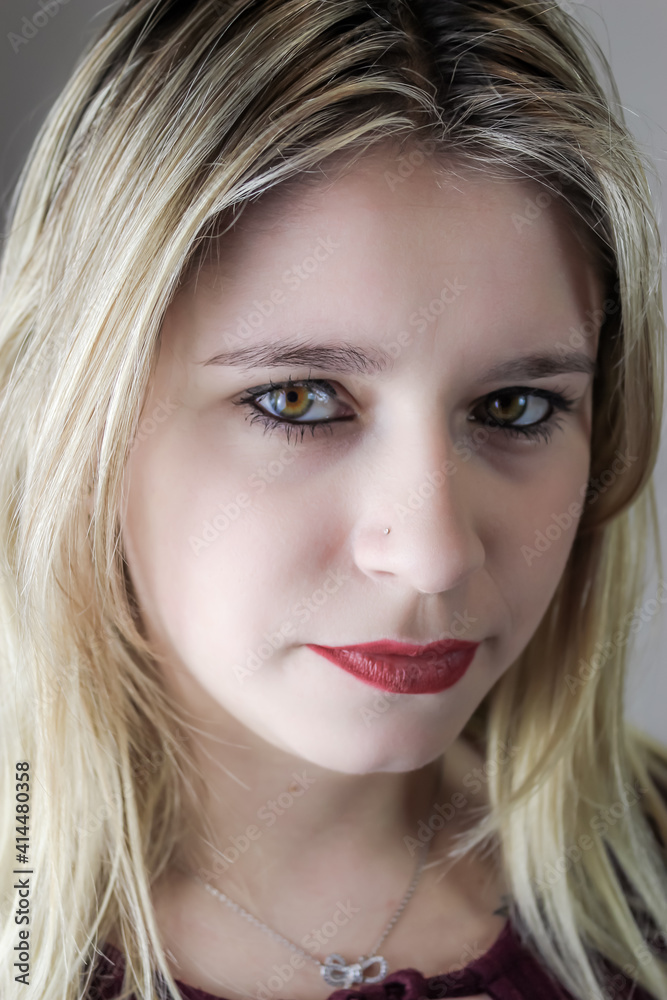 Close up portrait of a beautiful young woman with blonde hair and red lipstick Close up portrait of a beautiful young woman with blonde hair and red lipstick