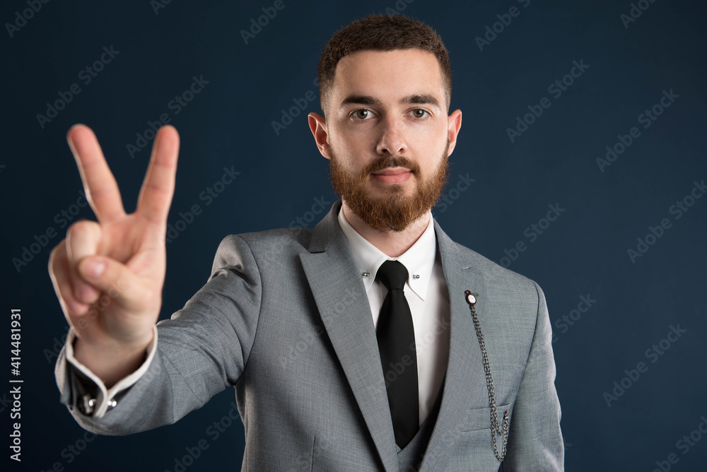 Young businessman showing peace sign Young businessman showing peace sign