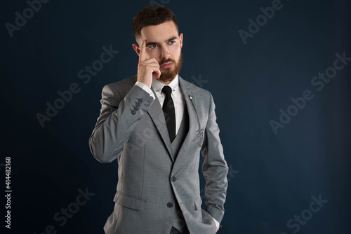 Handsome young businessman thinking about a deal