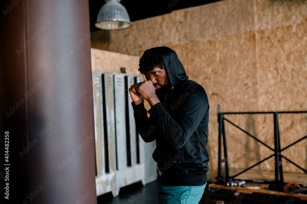 Young African American Boxer working out at a gym