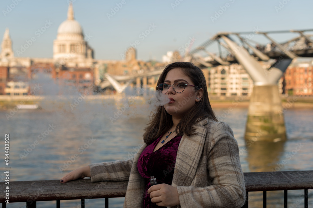Portrait of Portuguese woman wearing glasses and smoking with steam