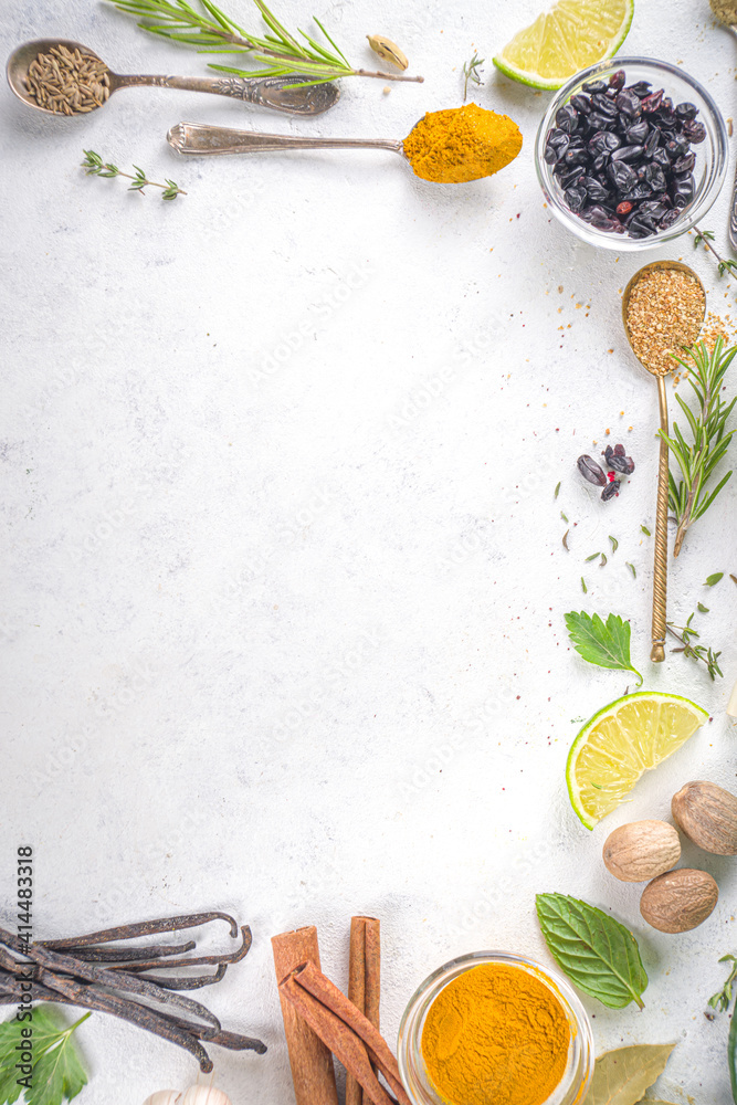 Fresh herbs, dried colorful spices. Cooking background flatlay with variety spices, herbs pepper, vanilla bean, cinnamon, basil, rosemary, chilli red green peppers, mint, parsley White table top view Fresh herbs, dried colorful spices. Cooking background flatlay with variety spices, herbs pepper, vanilla bean, cinnamon, basil, rosemary, chilli red green peppers, mint, parsley White table top view