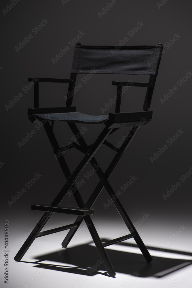 modern, black filmmaker chair on dark grey background, cinema concept modern, black filmmaker chair on dark grey background, cinema concept