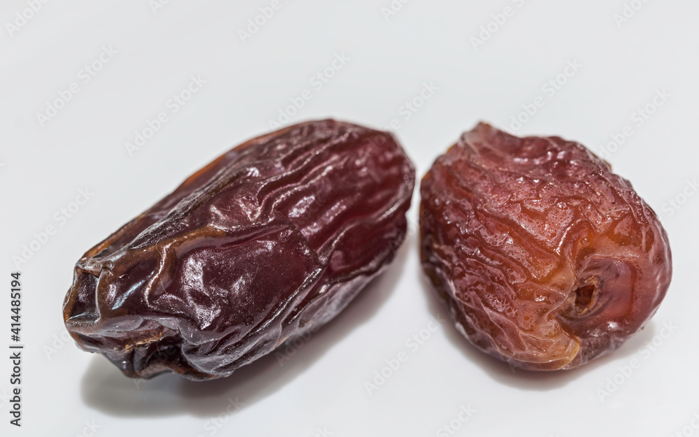 Two Fresh Dried Dates Fruit on White Background Two Fresh Dried Dates Fruit on White Background