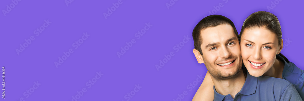 Love, relationship, lovers concept - studio portrait image of happy smiling embracing couple, man and woman in piggyback pose, isolate over violet purple color background. Copy space for text. Love, relationship, lovers concept - studio portrait image of happy smiling embracing couple, man and woman in piggyback pose, isolate over violet purple color background. Copy space for text.