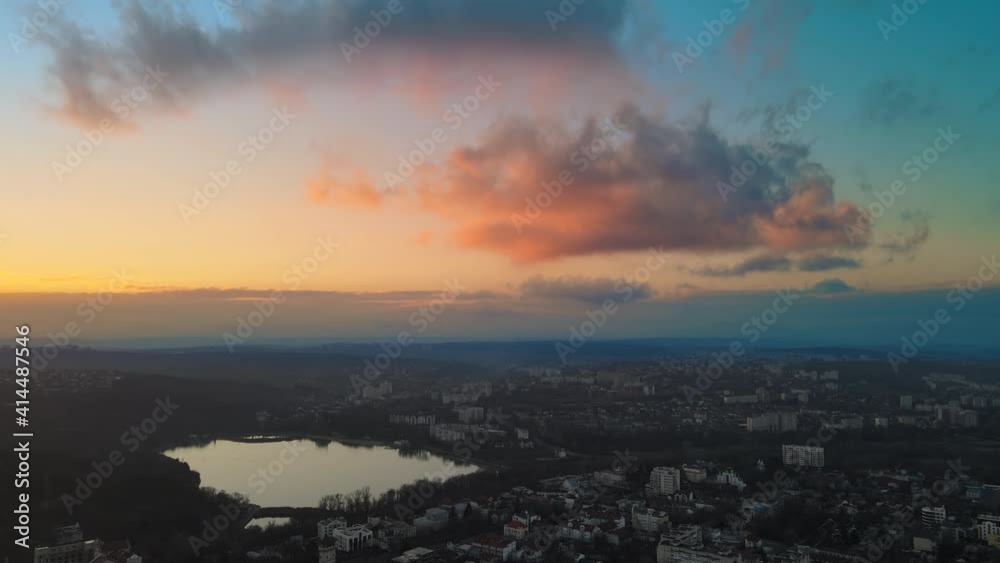 Aerial drone view of Chisinau at sunset. Panorama view of multiple buildings, bare trees, park, lake and hills. Moldova Aerial drone view of Chisinau at sunset. Panorama view of multiple buildings, bare trees, park, lake and hills. Moldova