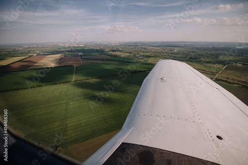 view from the window of a small plane on the city and fields, landscape