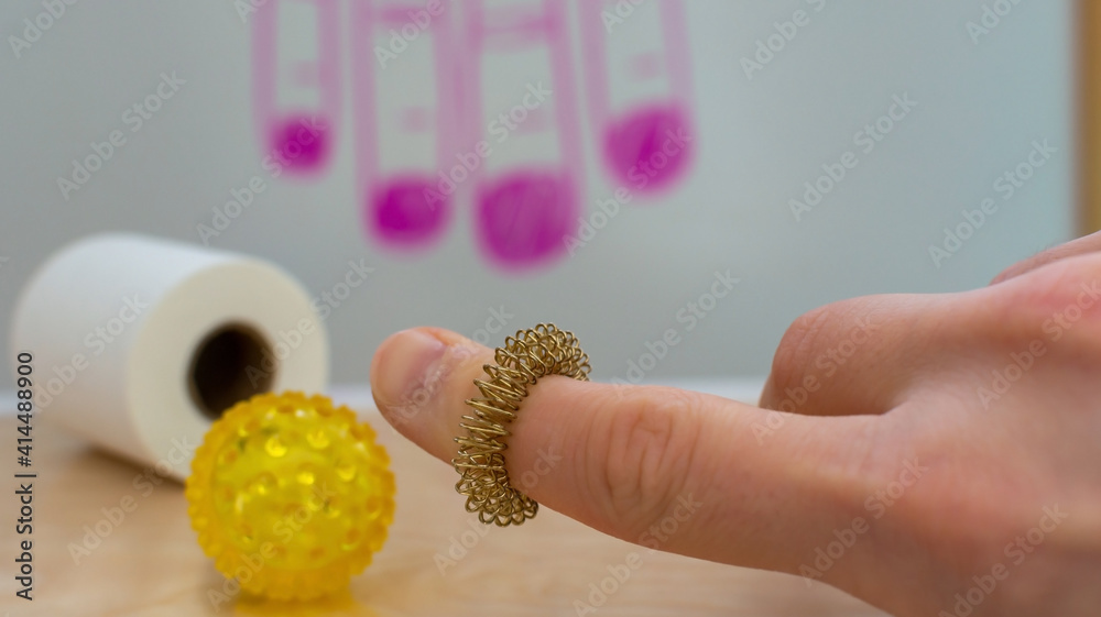 Sujok korean medicine methods. Using special ring instrument for  acupuncture treatment. Closeup man's hand with blurred background in  alternative medicine clinic. Reflexology finger physical treatment Stock  Photo | Adobe Stock