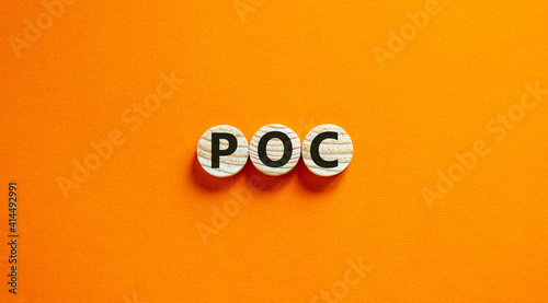 POC, proof of concept symbol. Wooden circles with the word POC, proof of concept. Beautiful orange background. Business and POC, proof of concept concept, copy space.