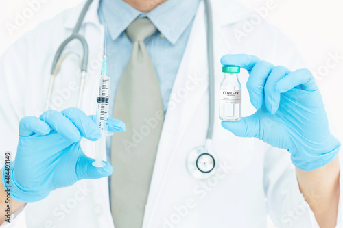 Coronavirus COVID-19 vaccine. Doctor holding Corona virus vaccine and syringe using for prevent COVID-19 infection. Medicine and Healthcare
