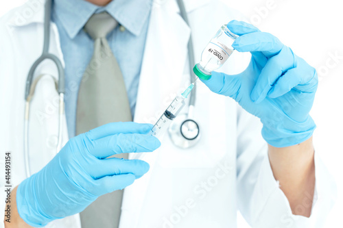 Coronavirus COVID-19 vaccine. Doctor holding Corona virus vaccine and syringe using for prevent COVID-19 infection. Medicine and Healthcare