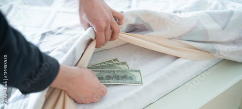 taking hidden stash of  cash money from the wardrobe at home